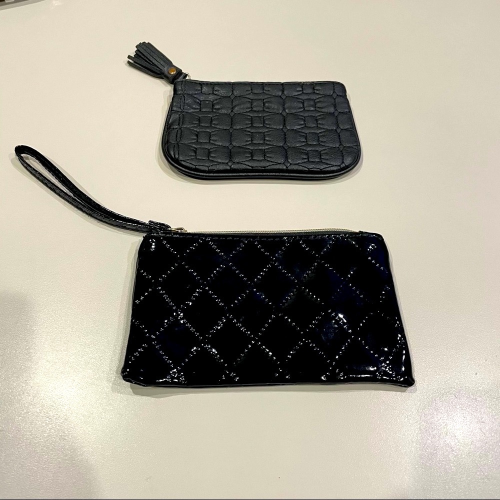 Two small black make up bags.